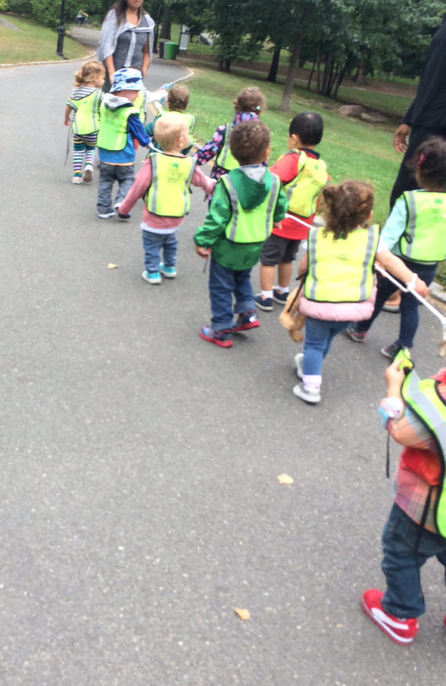 Pre-schoolers walking together attached by rope